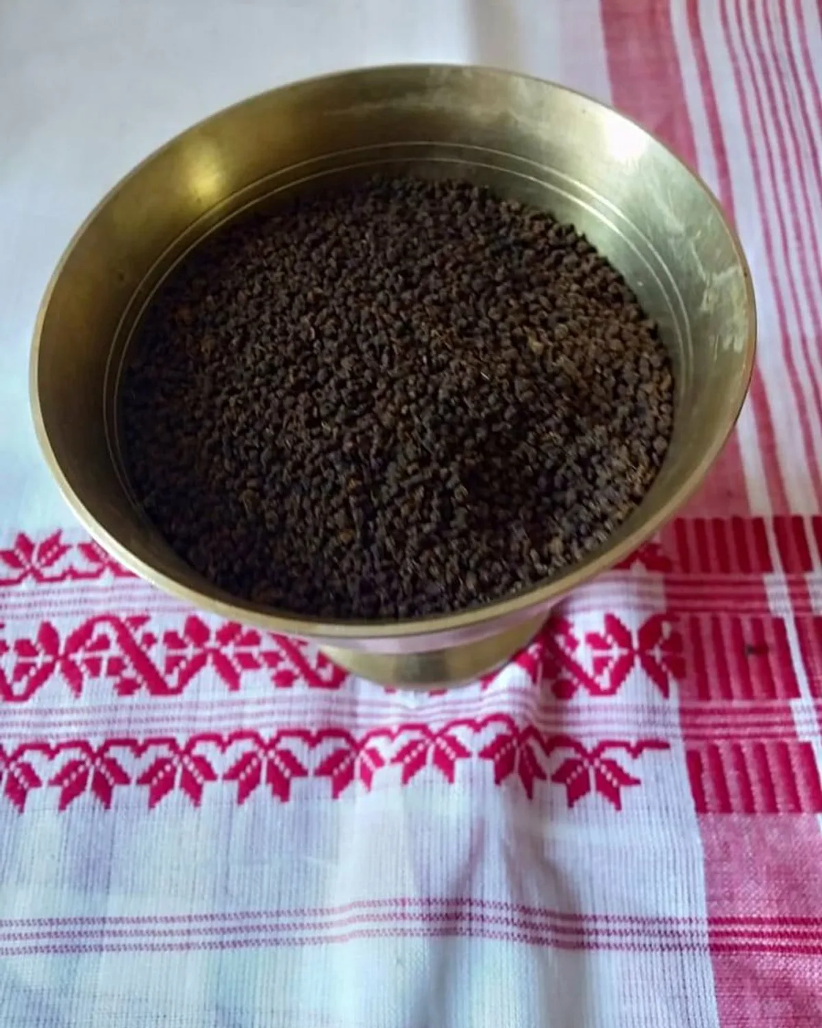Assam CTC tea sample in a brass bowl